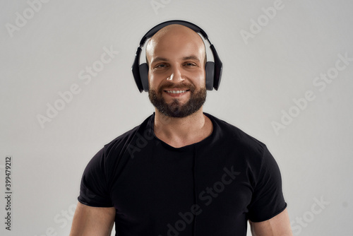 Portrait of young caucasian bodybuilder wearing headphones