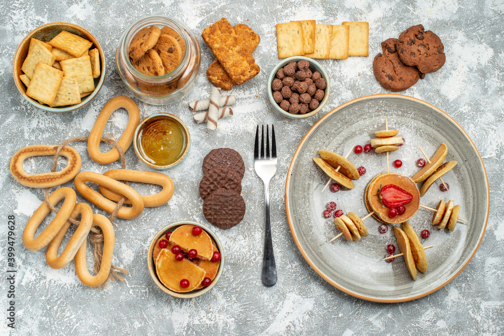 Breakfast time with stuffy pancakes cookies biscuits and honey on blue backgrounds