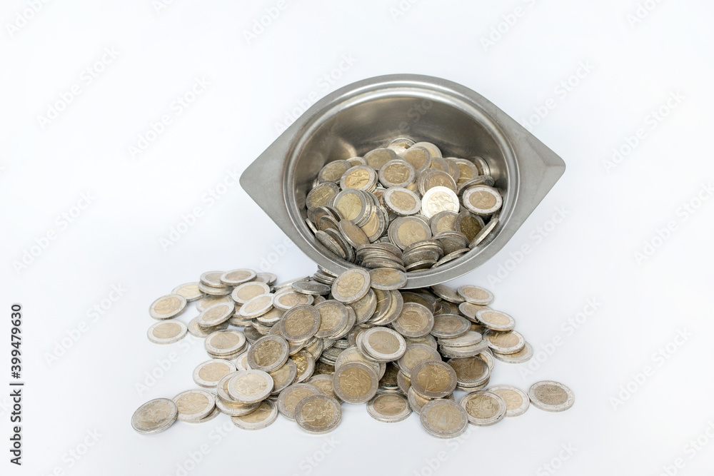 Dirty coins in a metal bowl. White background. Lithuanian money Dirty coins in a metal bowl. White background. Lithuanian money