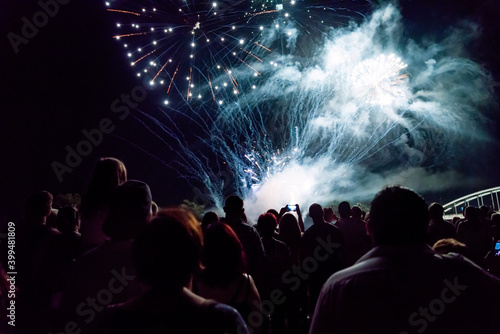 New year concept - cheering crowd and fireworks
