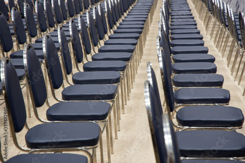 Empty chairs rows in the seminar hall. Place of meeting event or committee concept. © settapong