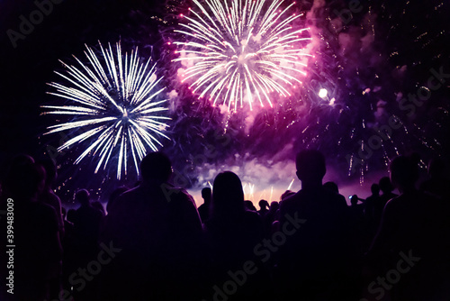 New year concept - cheering crowd and fireworks