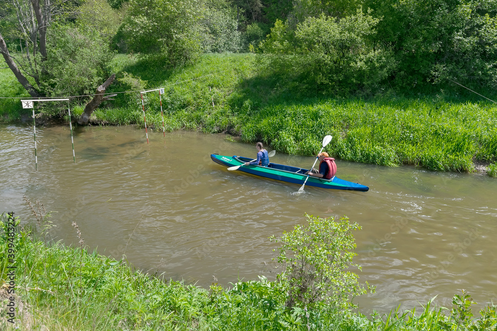  man and woman in a kayak compete on the river