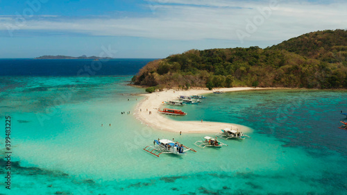 Aerial view tropical beach on island Ditaytayan. tropical island with white sand bar, palm trees and green hills. Travel tropical concept. Palawan, Philippines