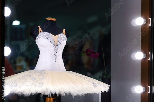 White ballet tutu on display for sale in ballet store accessory. Professional tutu and costume, showcase of ballet accessories shop.