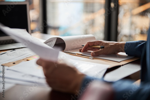 Tableau sur toile Skillful editor working with paperwork at his office