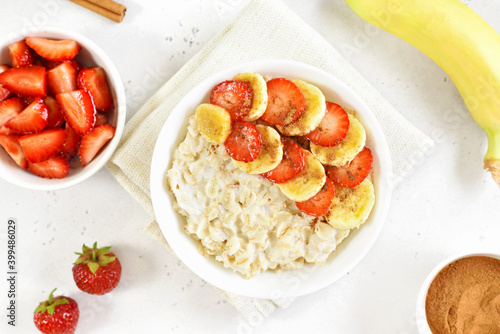 Oatmeal porridge with strawberry, banana in bowl