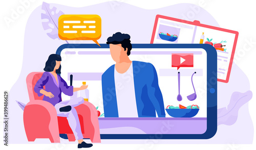 A girl watching food blog. The cook on mobile phone screen talks about the dish. Online lesson in cooking vegetable salad. Cooking learning application. Photo processing of professional chef