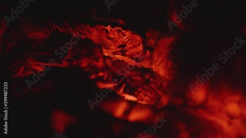 Smoldering wood in the village stove. Heat from a dying fire. Close up. Soft focus