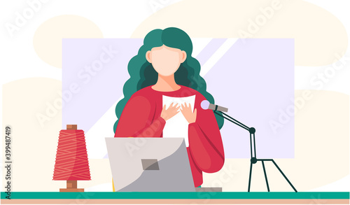 Girl in a red sweater sits at the table, shoots video and text from paper on a microphone. The woman reads the message and shoots it against the background of a large window next to a spool of thread