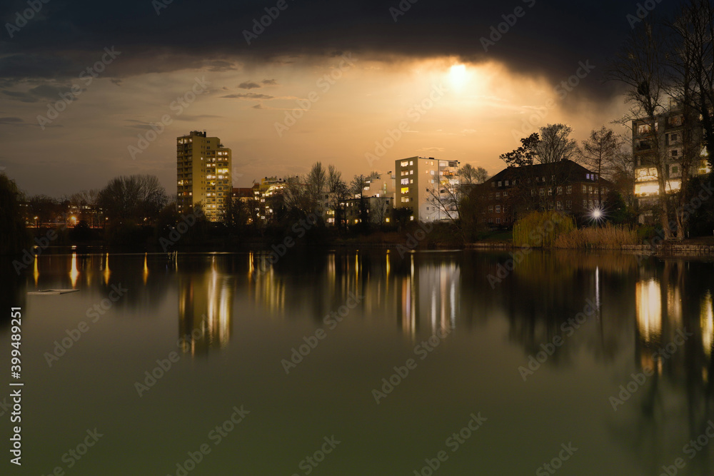 Lietzensee Park with adjacent buildings in the Berlin capital district of Charlottenburg on a winter December evening.