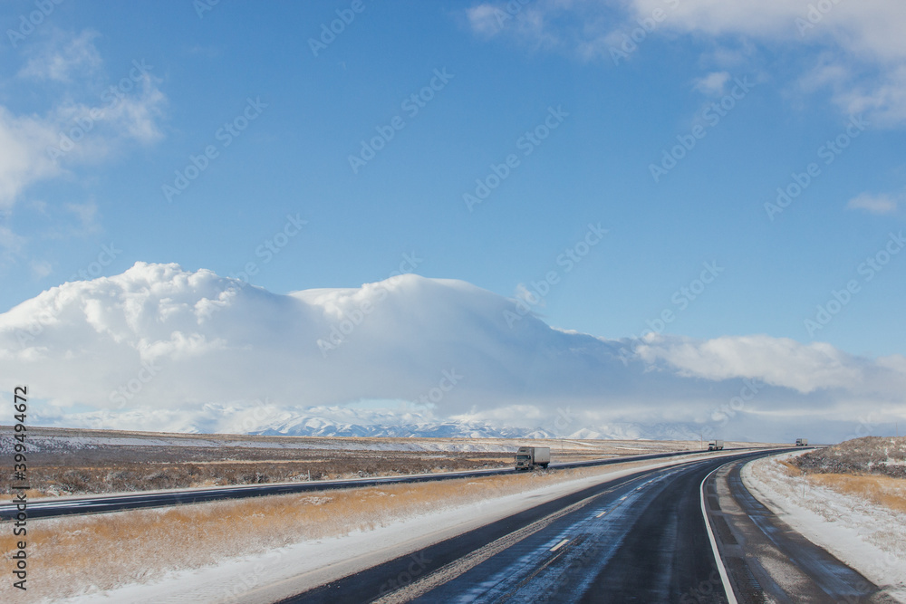 Winter snow highway among mountains. Trucks and cars are on a road. Utah, USA, 12-12-2019 Winter snow highway among mountains. Trucks and cars are on a road. Utah, USA, 12-12-2019