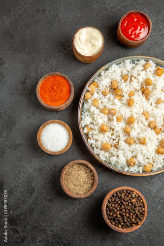 Vertical view of dinner background peas and rice meal with different spices mayonnaise ketchup photo