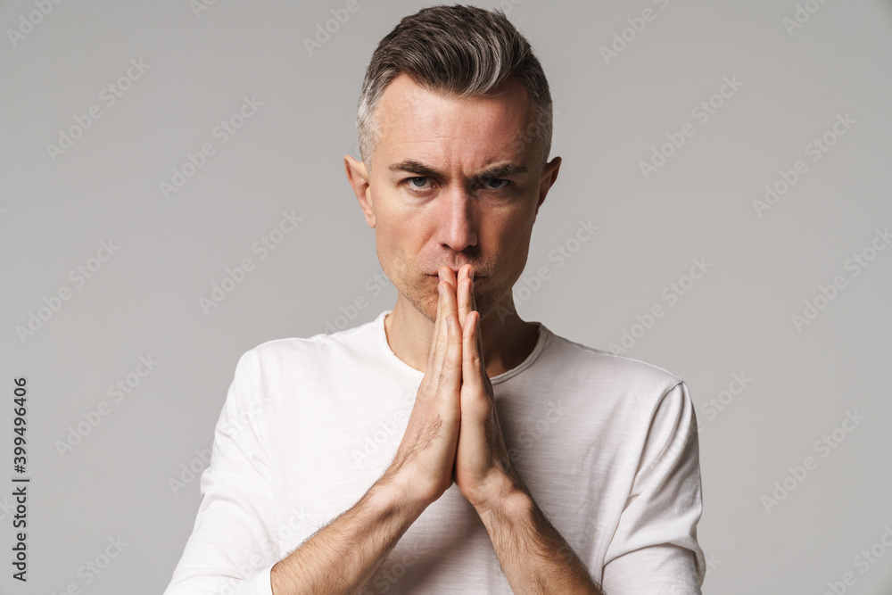 Worried man begging and praying with hands together Worried man begging and praying with hands together