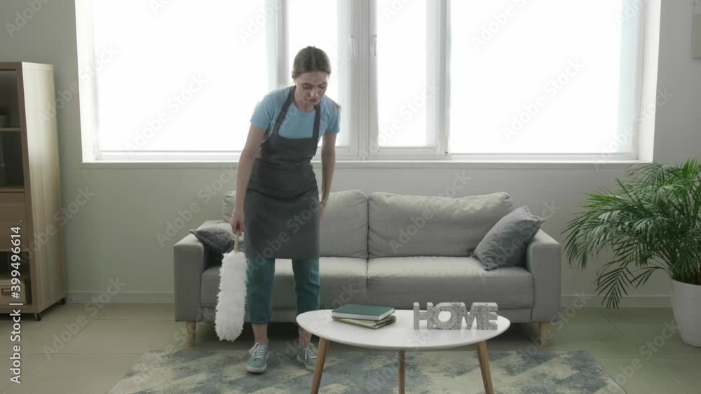 Tired young woman resting after cleaning her flat Tired young woman resting after cleaning her flat