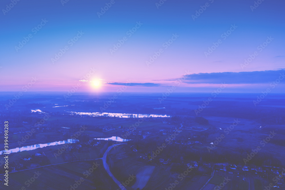 Rural landscape in the morning with the pink-blue sky. Aerial view of the countryside during sunrise