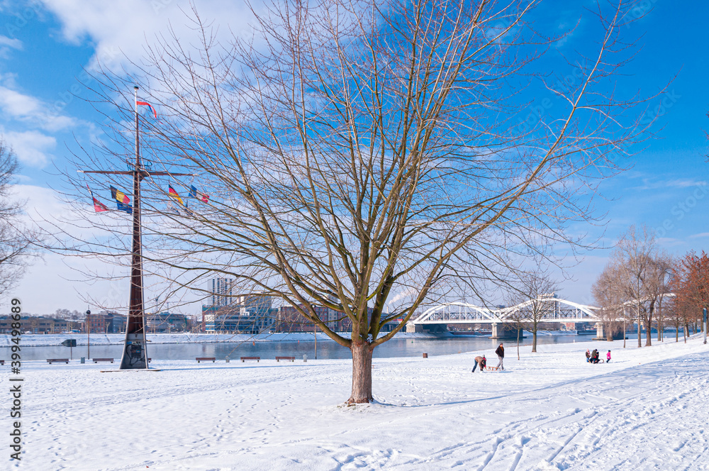 Mannheim, Germany. January 31th, 2010. In the morning, people stroll on the snow-covered meadows near the Rhine River. Mannheim, Germany. January 31th, 2010. In the morning, people stroll on the snow-covered meadows near the Rhine River.