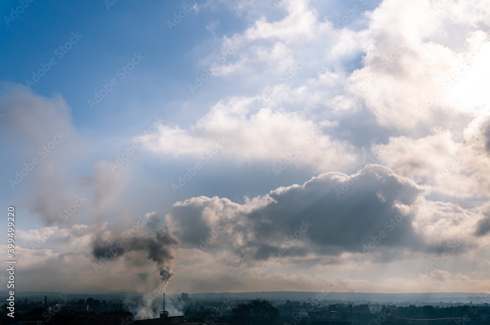 Chimney of a ceramic industrial oven drawing a black smoke