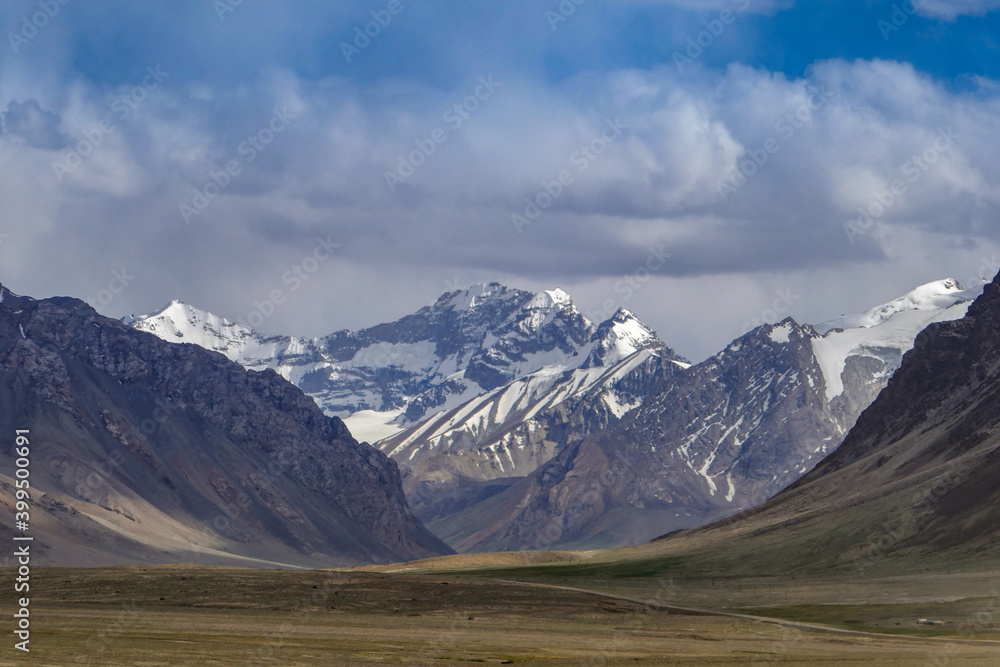 Beautiful landscape with snow-capped mountains along high-altitude Pamir Highway between Ak Baital pass and Karakul lake in Murghab district, Gorno-Badakshan, Tajikistan
