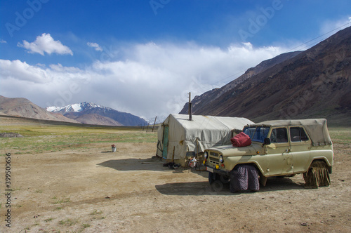 Kyrgyz nomad camp with tent and car along the Pamir Highway in high-altitude summer pasture between Ak Baital pass and Karakul lake in Murghab district, Gorno-Badakshan, Tajikistan