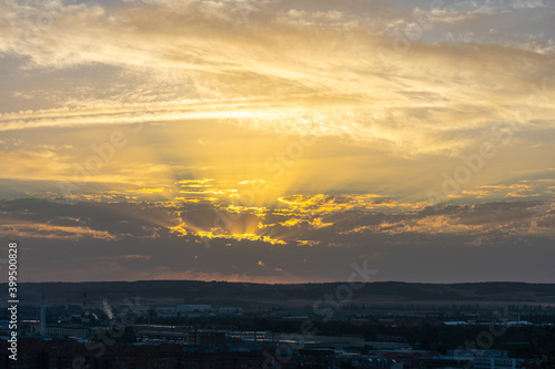 golden sunrise among clouds in summer