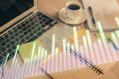 Multi exposure of forex graph drawing and desktop with coffee and items on table background. Concept of financial market trading © peshkova