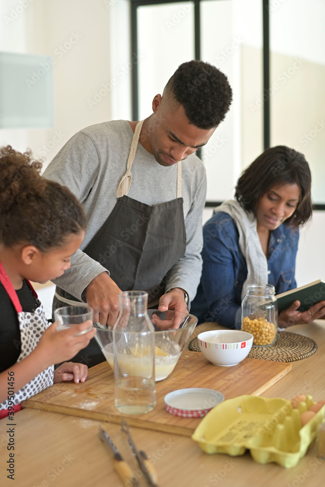 Happy family in home kitchen making homestyle american cookies Happy family in home kitchen making homestyle american cookies