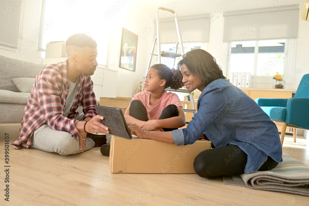 Recently moved family looking at things to buy online for new house Recently moved family looking at things to buy online for new house