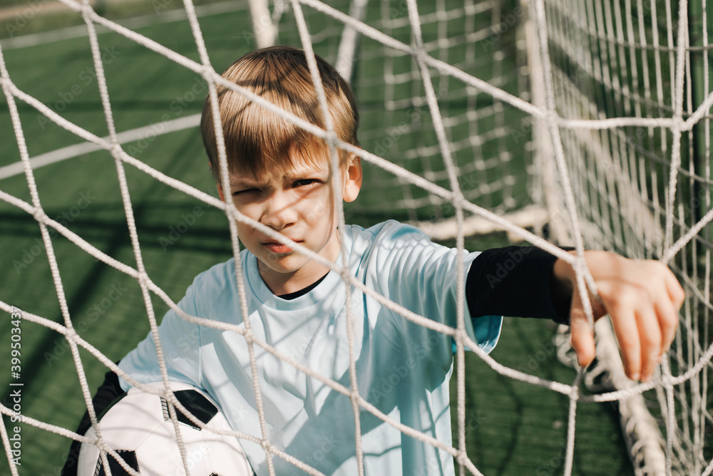 Boy player on football field with ball Boy player on football field with ball