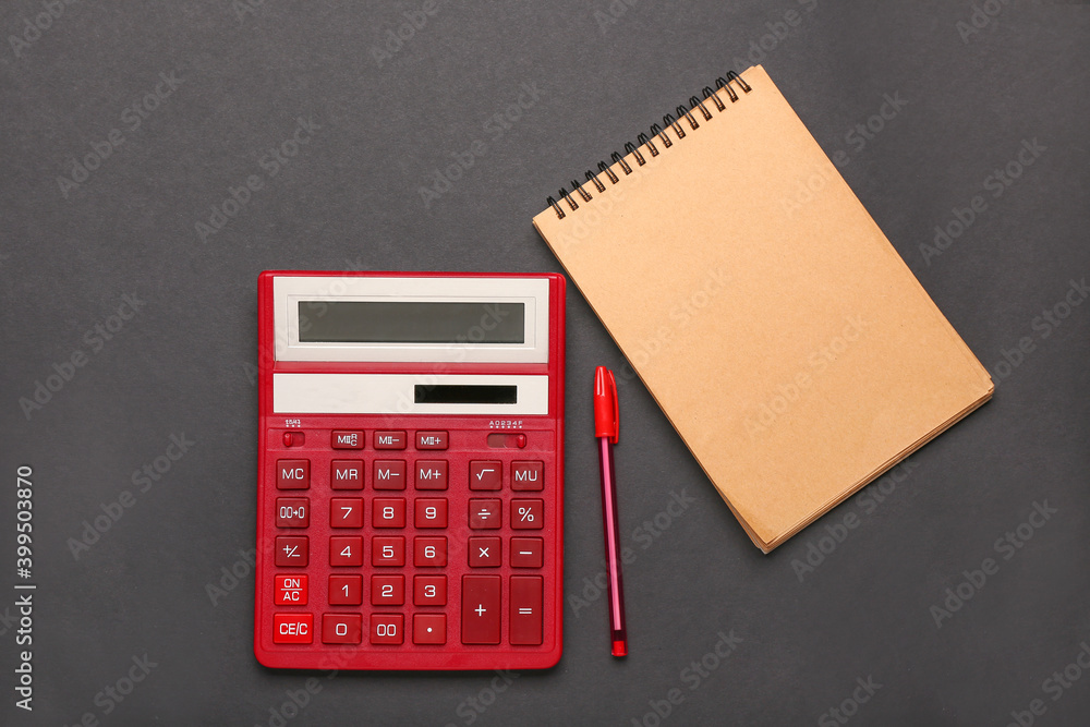 Modern calculator and stationery on dark background Modern calculator and stationery on dark background