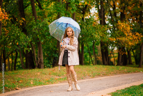 Young attractive smiling girl under umbrella in autumn forest © Ivan Zelenin
