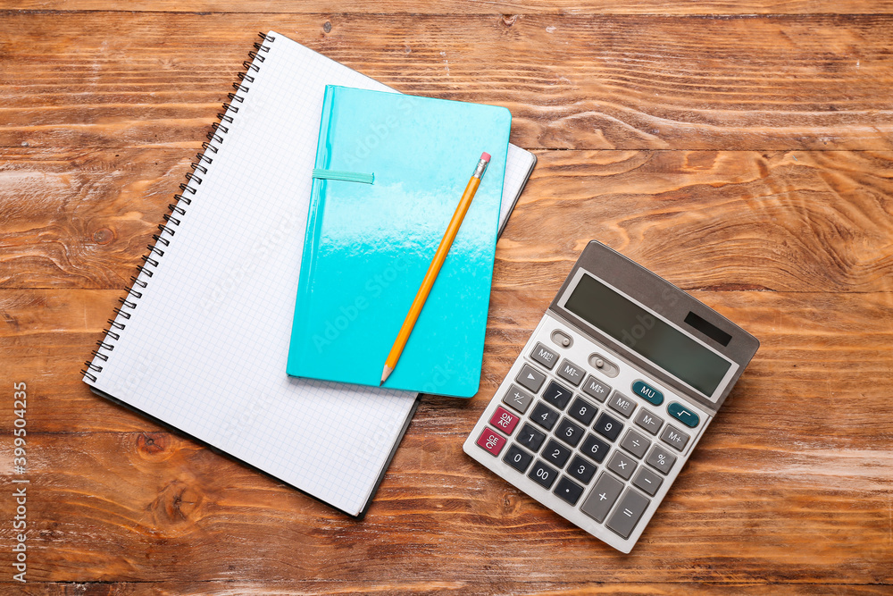 Modern calculator and stationery on wooden background Modern calculator and stationery on wooden background