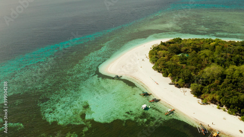 Beautiful beach on tropical island surrounded by coral reef, top view. Mantigue island. Small island with sandy beach. Summer and travel vacation concept, Camiguin, Philippines, Mindanao