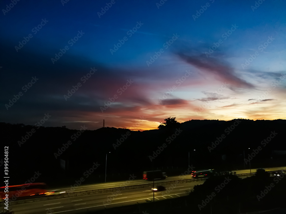 Sunset in pink and blue near the highway.