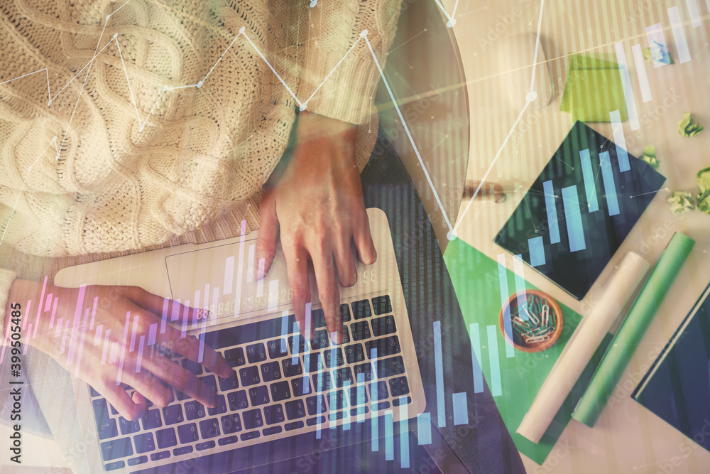 Multi exposure of woman hands working on computer and forex chart hologram drawing. Top View. Financial analysis concept. Multi exposure of woman hands working on computer and forex chart hologram drawing. Top View. Financial analysis concept.