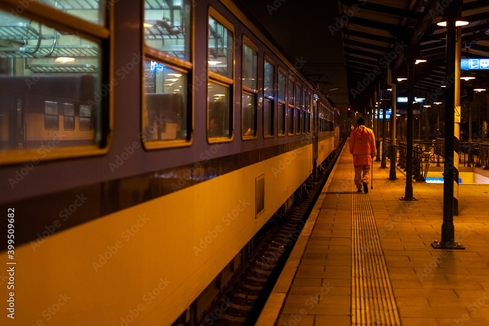 The train technician checks the brakes of the night train at the station