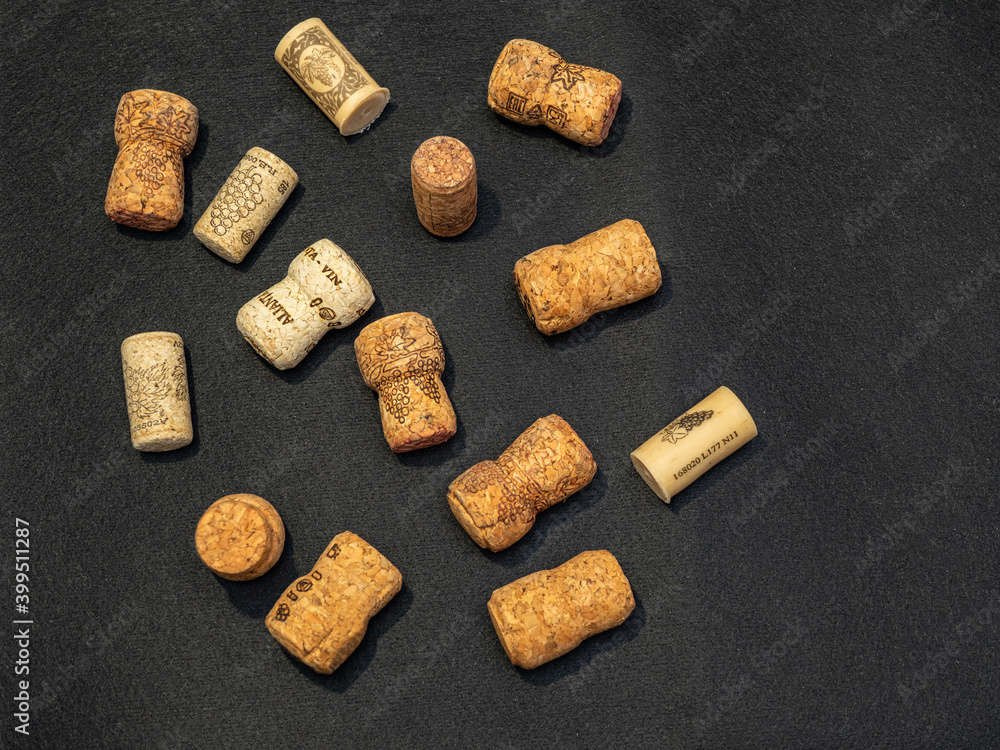lots of wine and champagne corks on a black background