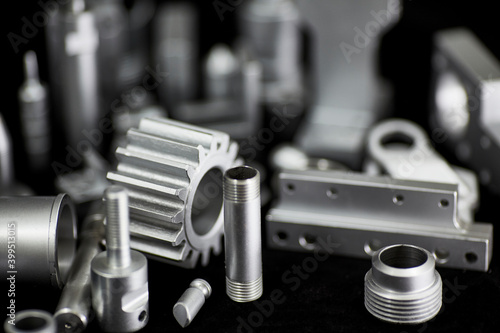 Shiny steel parts on a black background. Regular industrial metal production pattern.