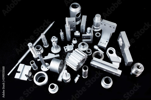 Shiny steel parts on a black background. Regular industrial metal production pattern.