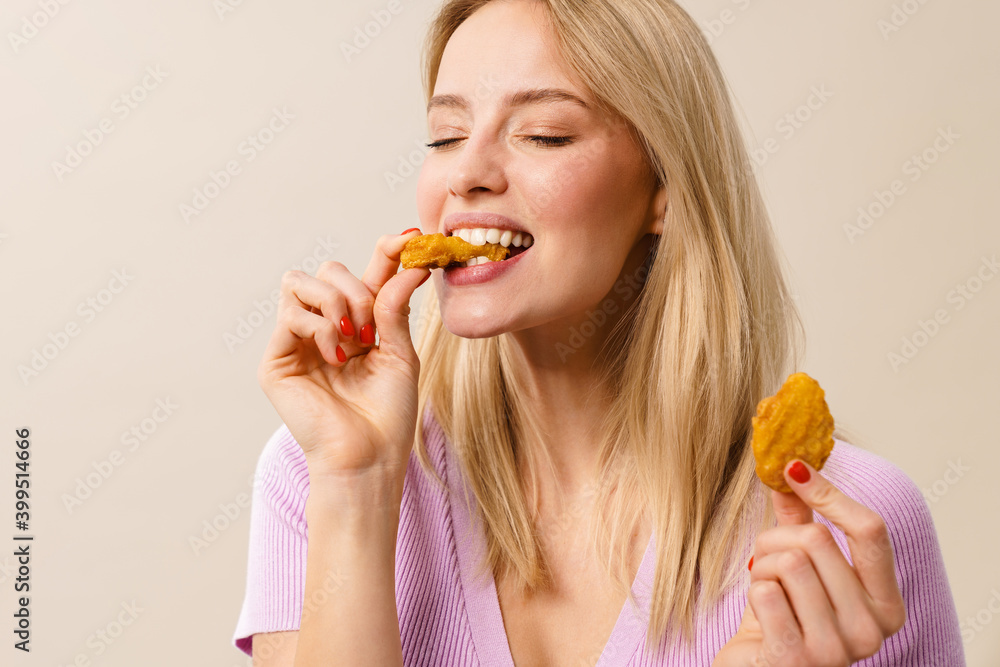 Cheerful beautiful girl smiling while eating nuggets on camera Cheerful beautiful girl smiling while eating nuggets on camera