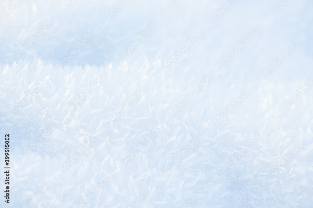 Fototapeta premium Hoarfrost background texture. Fresh ice and snow winter backdrop with snowflakes and mounds. Seasonal wallpaper. Frozen water geometrical shapes and figures. Cold weather atmospheric precipitation.