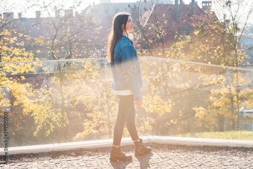 portrait of young dark haired woman exploring old beautiful city. Travel concept photo