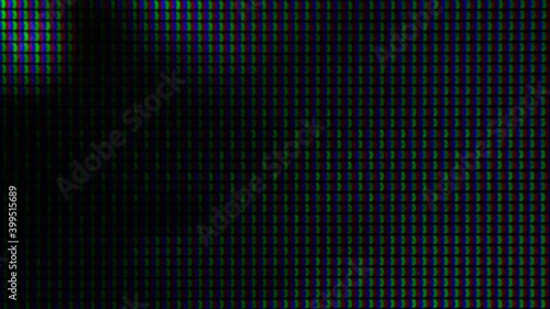 Macro shot of a computer display or TV screen. Multi-colored pixels as trace elements creating an image on an LED or LCD screen. photo