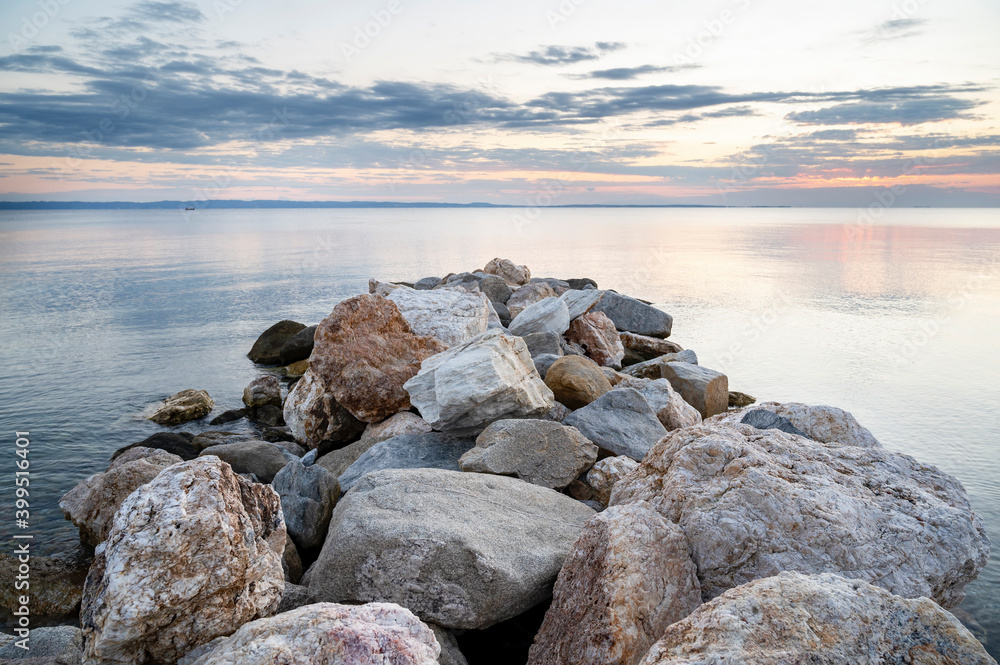 Rocks on the Aegean sea coast in Skala Fourkas, Greece