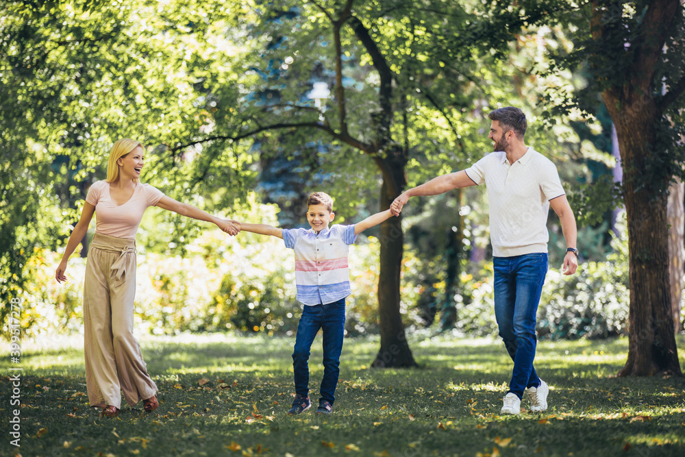 Young happy family with one children in the summer park Young happy family with one children in the summer park