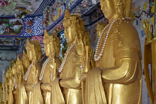 Golden Buddha Statues Standing in Karana Mudra, Center Focus, Linh Phuoc Pagoda, Da Lat, Vietnam photo