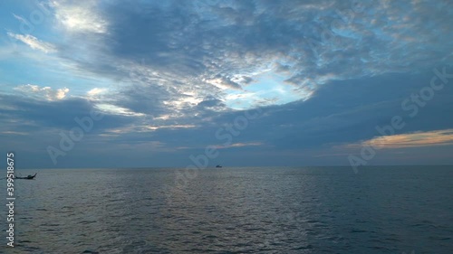 Boat sailing on the sea across a sky line in the evening sky shade