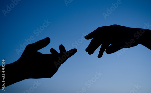 Silhouette of hands. Sky. Sunset. Silhouette of hands at sky background. Care and support concept.