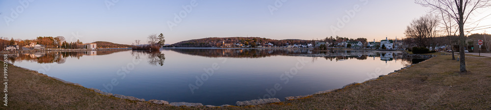 Panorama at sunrise on an early spring morning.  Lake Winnipesaukee and the town of Meredith, New Hampshire, USA.
