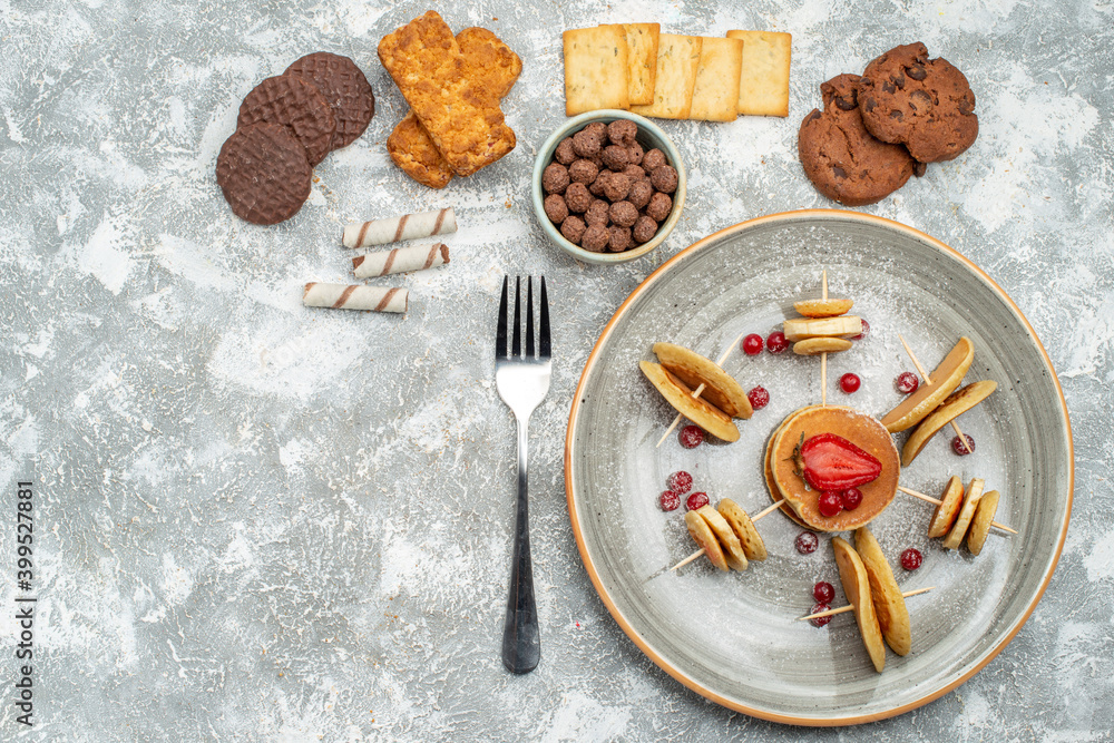 Overhead view of breakfast time with stuffy pancakes cookies biscuits on blue backgrounds Overhead view of breakfast time with stuffy pancakes cookies biscuits on blue backgrounds